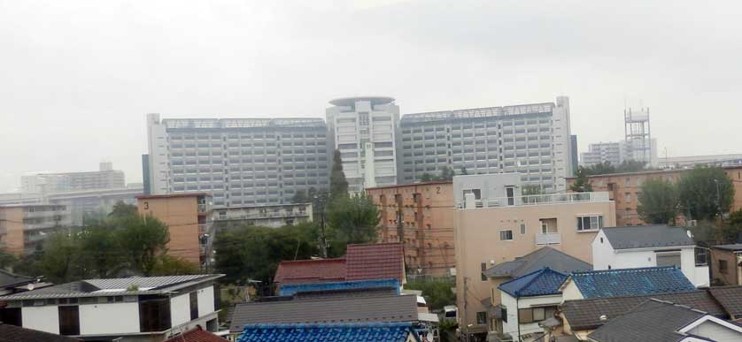 The prison seen towering over the surrounding houses from Kosuge train station.